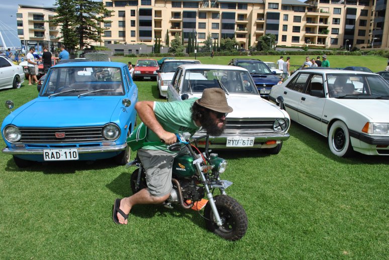 11 - Dave on Honda Z50 monkeybike in front of Datsuns.JPG