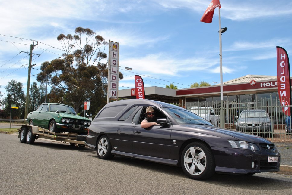 18 October - 21 - Cootamundra - Dave in VY Sandman with Bellett GTR near Holden and Isuzu signs.JPG